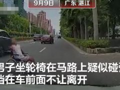 男子坐着轮椅在马路上碰瓷 男子坐轮椅拦截车辆不让离开